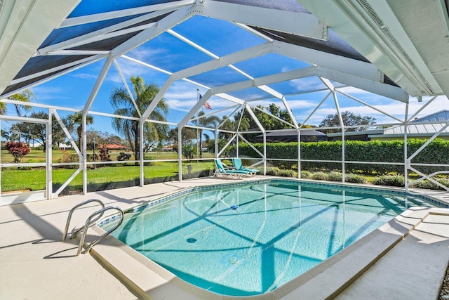 view of swimming pool featuring a yard, a patio, and glass enclosure