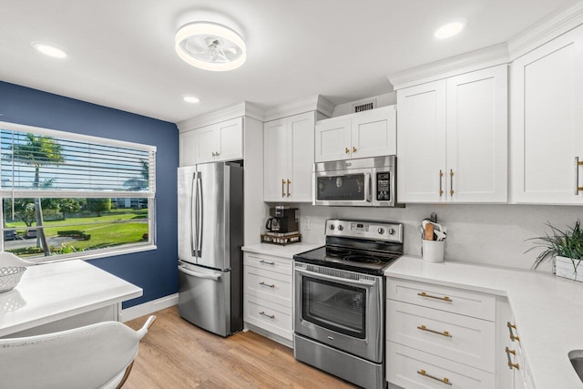 kitchen with white cabinetry, light hardwood / wood-style flooring, and stainless steel appliances