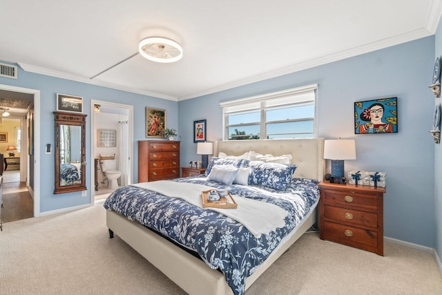 bedroom with crown molding, light colored carpet, and ensuite bathroom