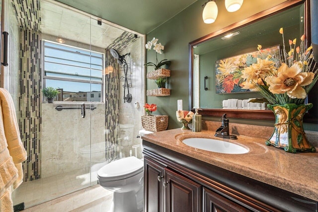 bathroom featuring vanity, toilet, and a shower with shower door