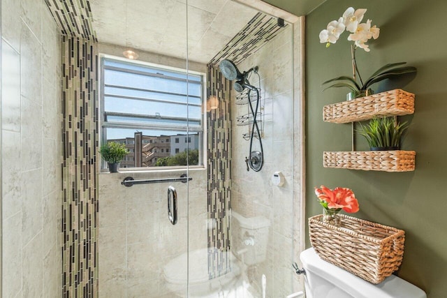 bathroom featuring an enclosed shower and toilet