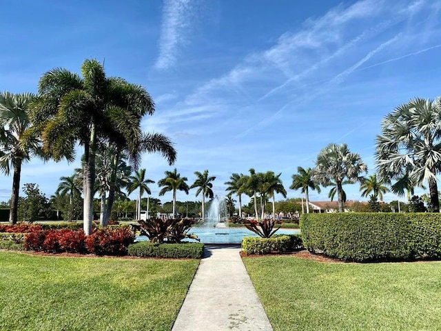 view of property's community with a lawn