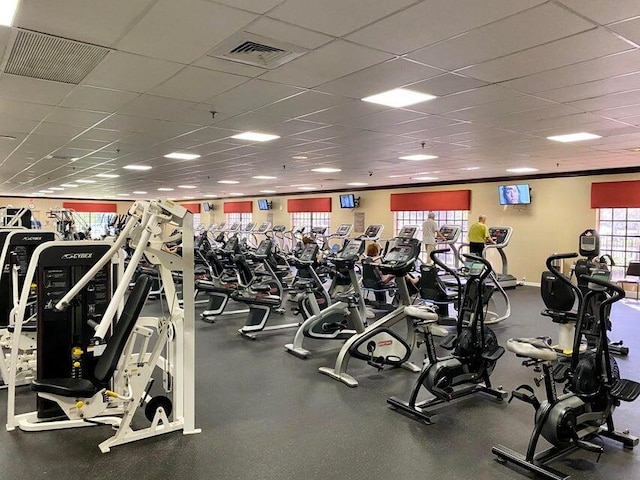 exercise room featuring ornamental molding and a drop ceiling