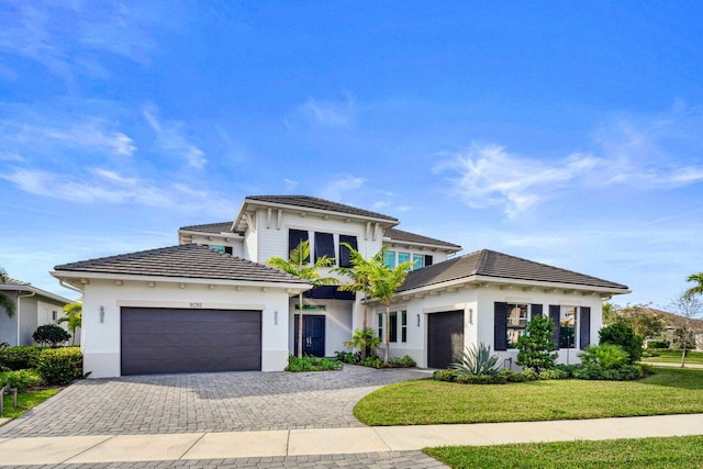 view of front of property with a garage and a front yard