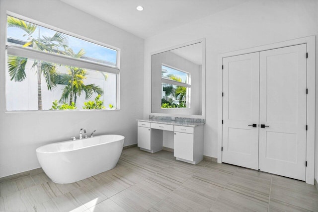 bathroom with a wealth of natural light and a washtub