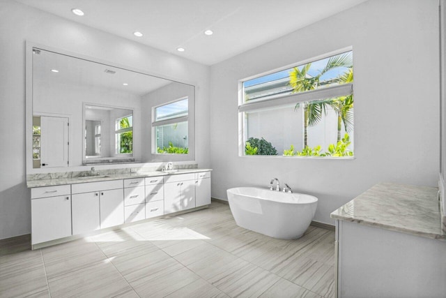 bathroom featuring vanity and a tub