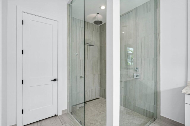 bathroom with vanity and tiled shower