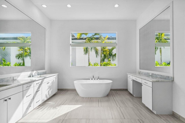 bathroom with vanity and a tub