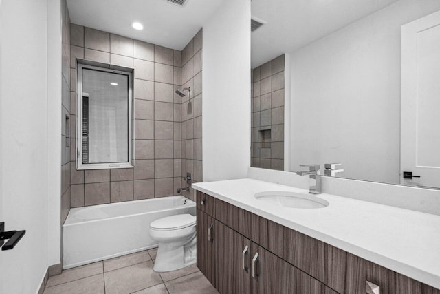 full bathroom featuring tiled shower / bath, vanity, toilet, and tile patterned floors