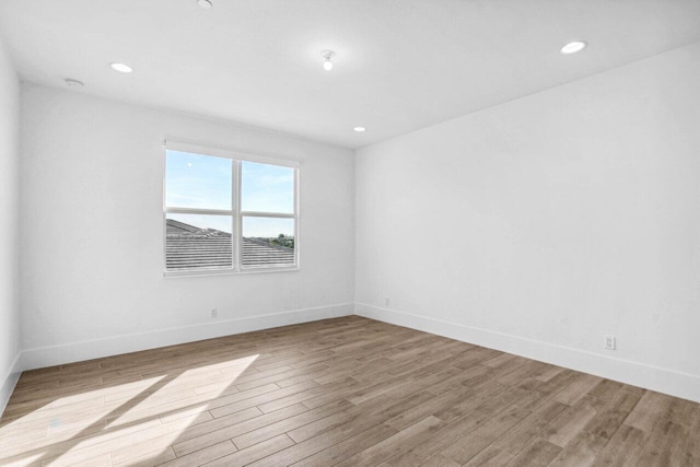 spare room featuring light hardwood / wood-style floors