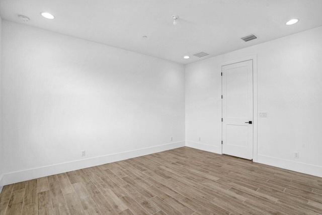 spare room featuring light hardwood / wood-style floors