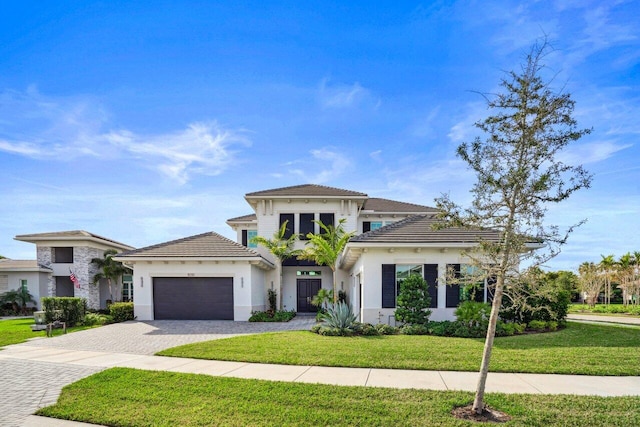 view of front of property with a garage and a front lawn