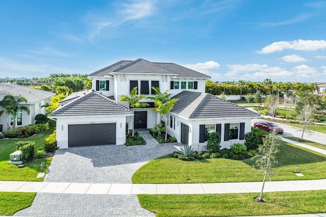 view of front of home featuring a garage and a front lawn