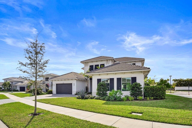 view of front of property with a garage and a front lawn