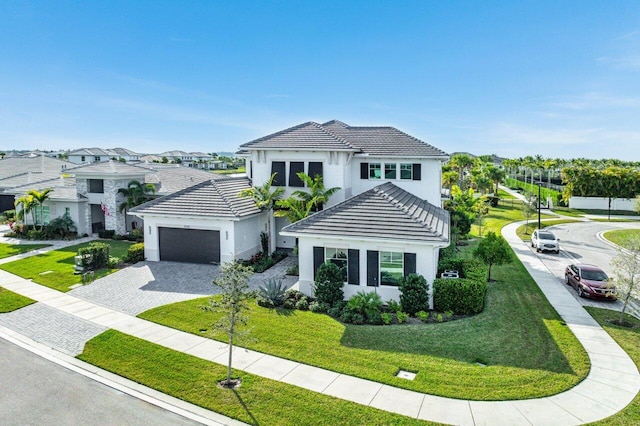 view of front of property with a garage and a front yard