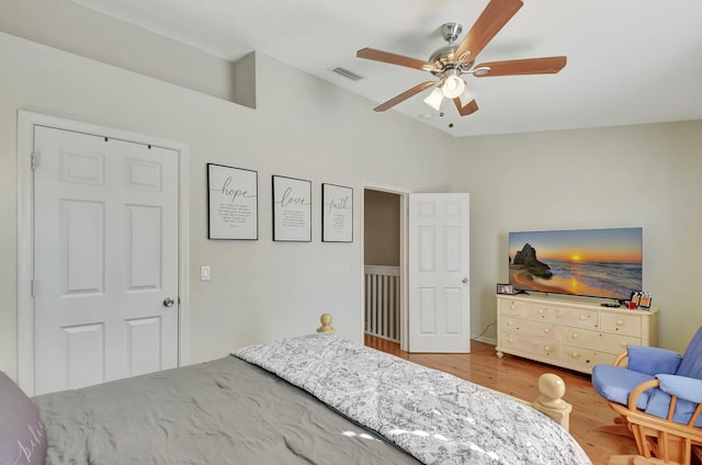 bedroom with visible vents, wood finished floors, a ceiling fan, and vaulted ceiling