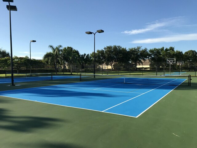 view of tennis court featuring fence