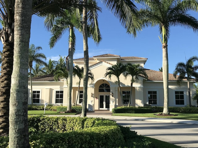 view of front facade with french doors and stucco siding