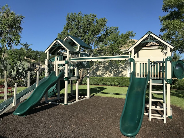 view of jungle gym featuring a lawn