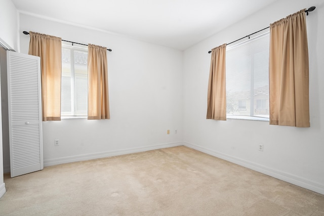 unfurnished room with light carpet