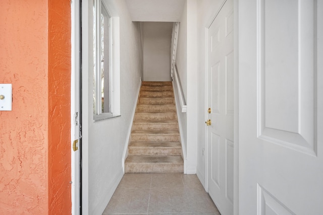 stairway with tile patterned floors