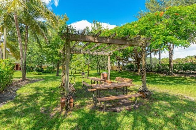 view of community featuring a pergola and a lawn