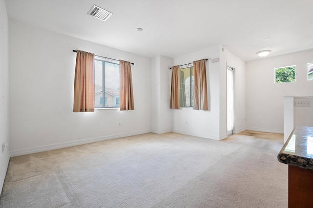 empty room featuring light carpet