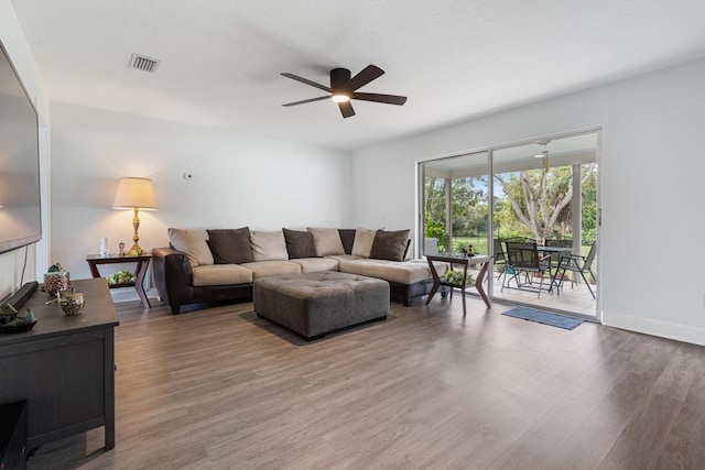 living room featuring hardwood / wood-style flooring, a textured ceiling, and ceiling fan