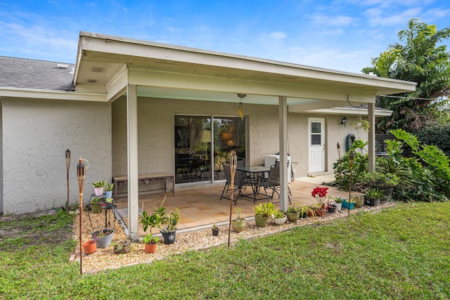 back of house featuring a yard and a patio area