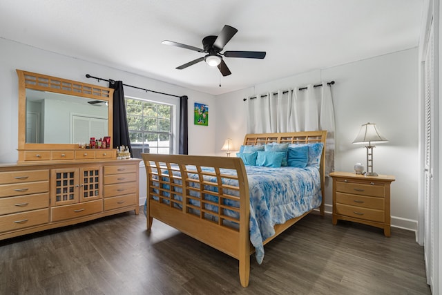 bedroom with dark hardwood / wood-style floors and ceiling fan