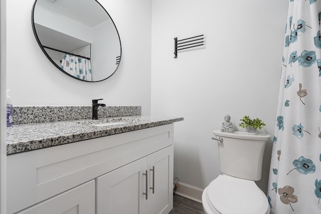 bathroom featuring a shower with curtain, vanity, hardwood / wood-style floors, and toilet