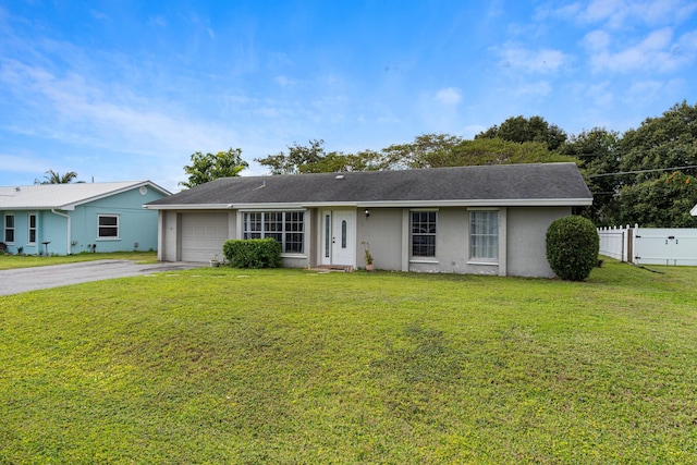 ranch-style home with a garage and a front lawn