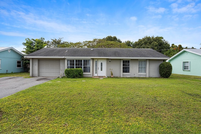 single story home featuring a garage and a front lawn