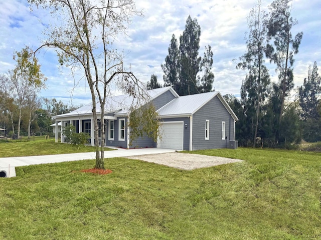 ranch-style house featuring a garage, a front yard, and central air condition unit