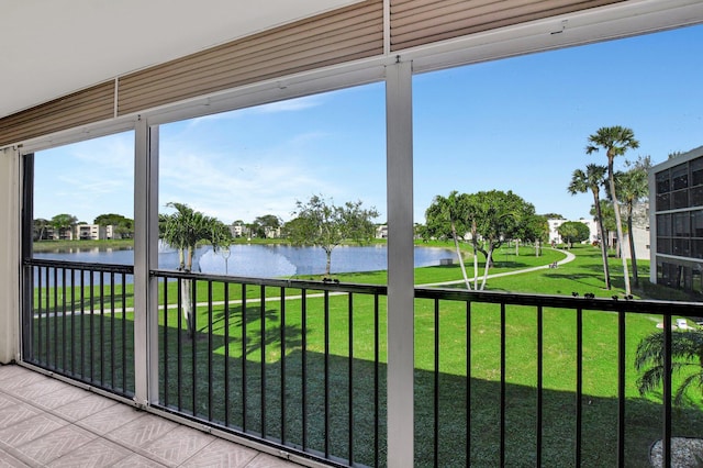 unfurnished sunroom with a water view