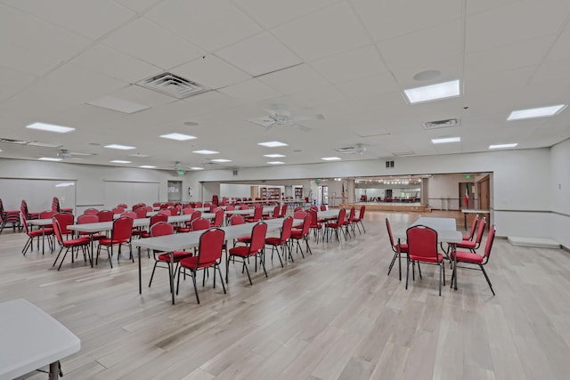 dining area featuring a paneled ceiling and light hardwood / wood-style floors