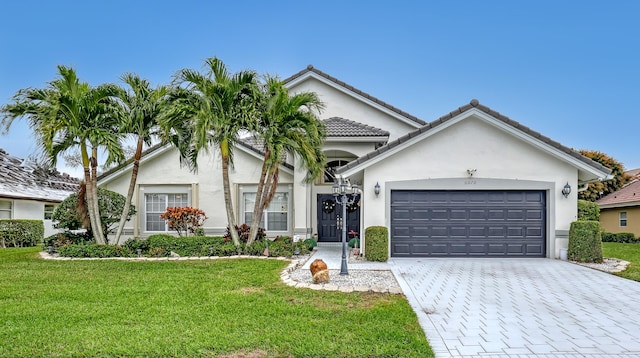 view of front of house with a garage and a front lawn