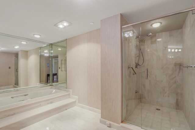 bathroom featuring separate shower and tub