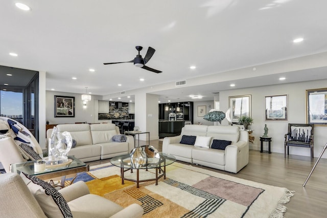 living room featuring light hardwood / wood-style floors and ceiling fan