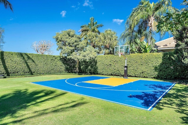 view of basketball court with a lawn