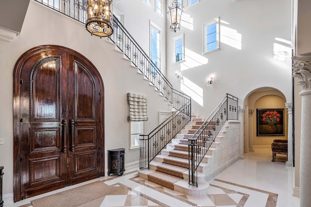 foyer entrance with a high ceiling and an inviting chandelier