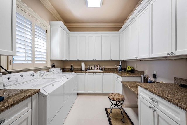 laundry area with cabinets, ornamental molding, washer and dryer, and light tile patterned floors