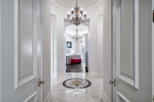 hallway featuring a notable chandelier