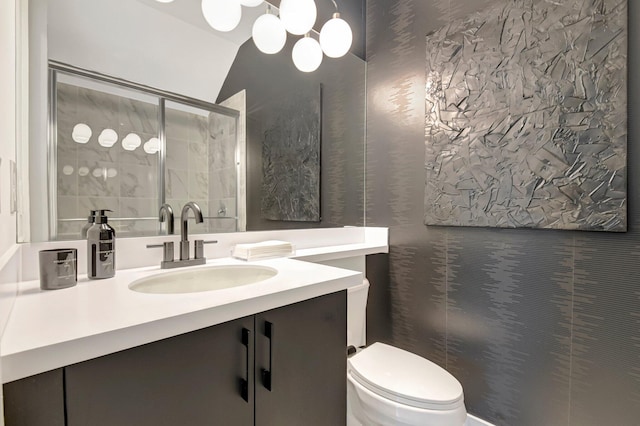 bathroom with toilet, a shower with shower door, a chandelier, vaulted ceiling, and vanity