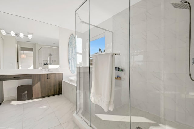 bathroom with vanity and shower with separate bathtub