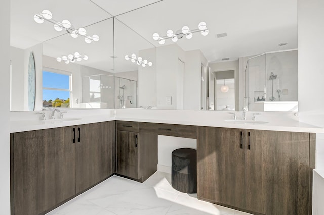 bathroom with vanity and a shower with door