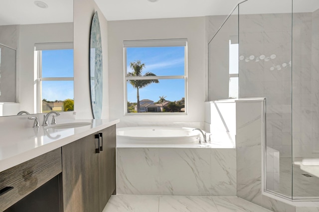 bathroom featuring vanity, plus walk in shower, and a healthy amount of sunlight