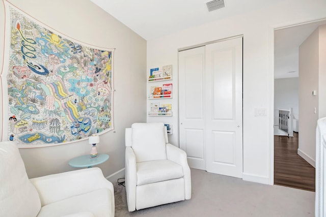 sitting room with carpet flooring and vaulted ceiling