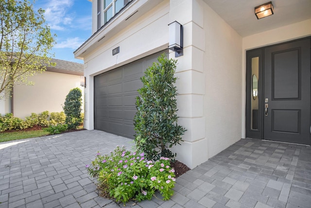 view of exterior entry featuring a garage