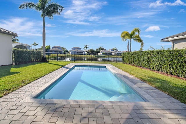 view of swimming pool with a patio, a water view, and a lawn